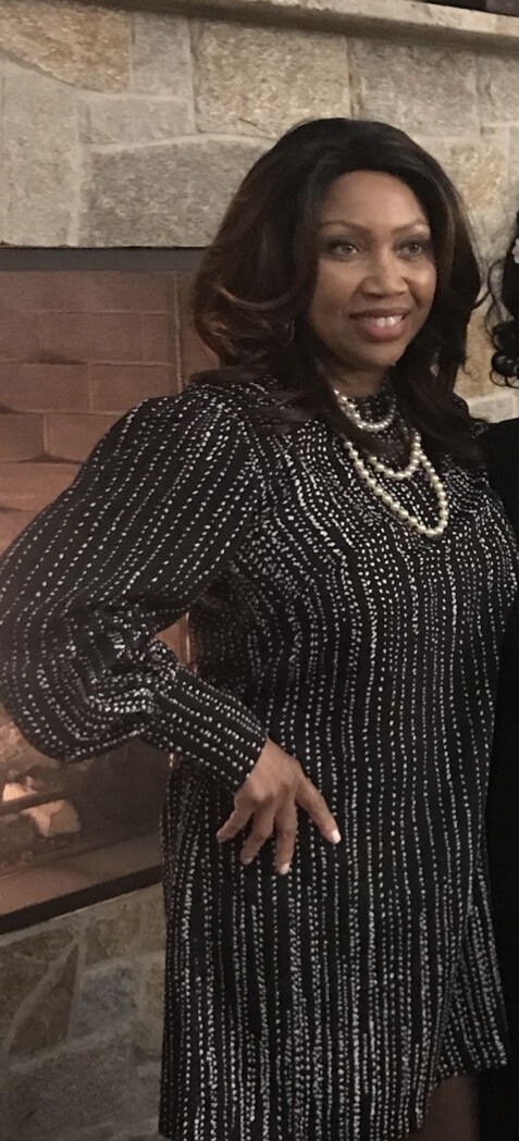 Ms. Dakota in dark dress